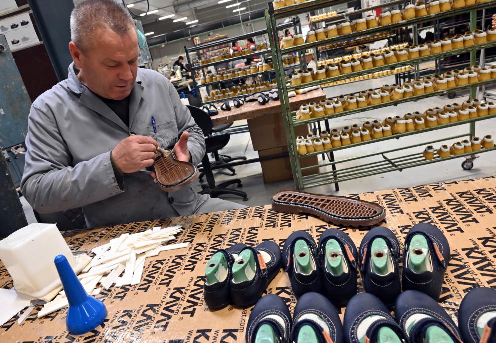 A Bosnian worker making shoes.jpg